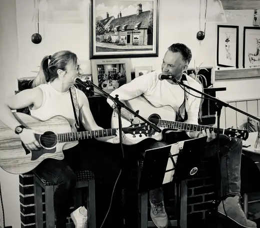 Black-and-white photograph of the acoustic duo