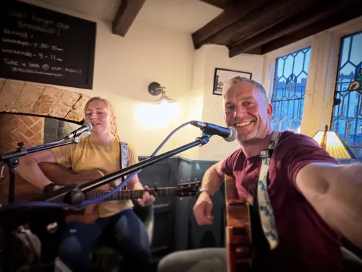 Playing beside a pub fireplace